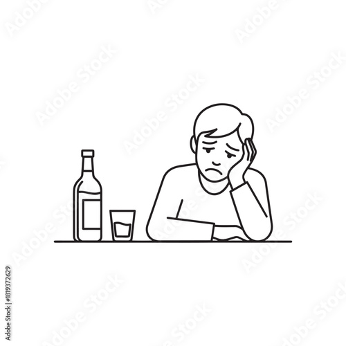 Depressed man sitting alone with a bottle of alcohol and a glass, struggling with addiction, isolated on