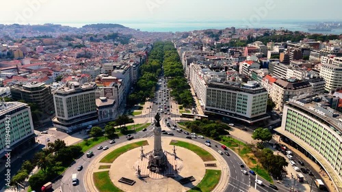 Lisbon at Sunset from Above –  Drone Flight Over Historic Rooftops, Red Palms and Oceanfront City Square. Portugal Aerial 