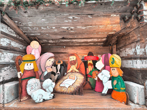 A nativity scene depicts the birth of Jesus, surrounded by Mary, Joseph, and various characters. The figures are brightly colored and cartoonish, giving a whimsical feel.