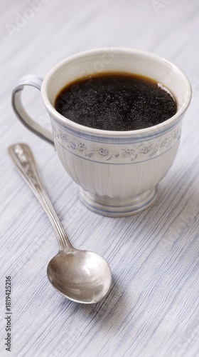 a cup of black coffee sits on the table