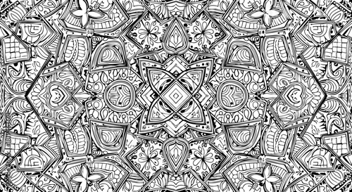 Intricate black and white mandala pattern with detailed geometric symmetry and organic floral motifs creating a mesmerizing visual experience for creative projects.