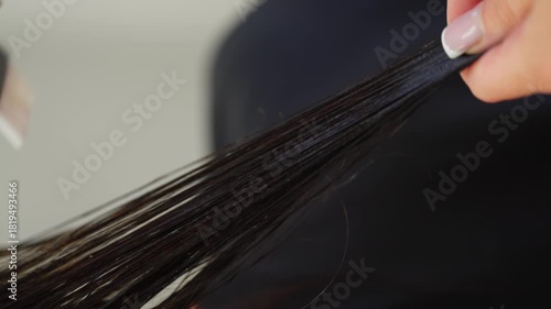 Close-up of applying the product to hair with a brush in a salon. High quality 4k footage