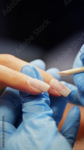 Pushing back the cuticle with an orange stick for a manicure. High quality 4k footage
