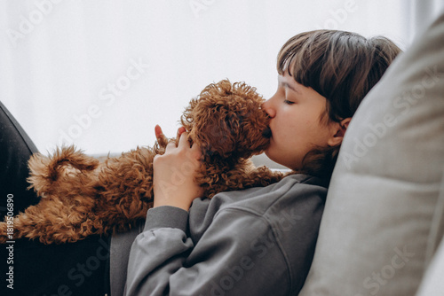 Little Girl Holding a Brown Poodle Puppy