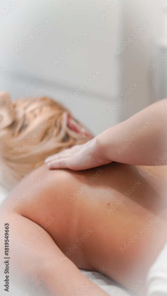 © Наталья Добровольска - Gentle massage hands working on blonde client creating calm salon atmosphere. © Наталья Добровольска - Gentle massage hands working on blonde client creating calm salon atmosphere.