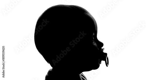 Newborn baby's profile with pacifier in mouth artistic black and white
