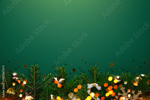 Christmas background with xmas tree, Christmas golden decoration and sparkle bokeh lights on green background. Merry Christmas greeting card. Winter holiday theme. Happy New Year. Space for text