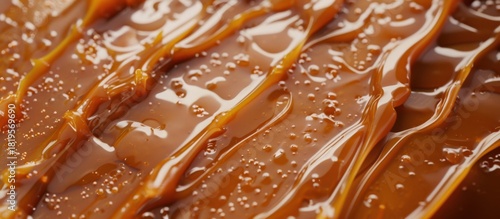Close-up of caramel sauce with sea salt crystals on a smooth surface, highlighting texture and glossy appearance.