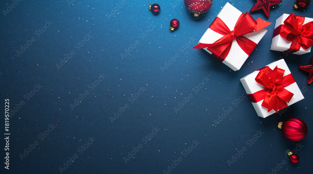 Obraz premium Merry Christmas and Happy Holidays greeting card, frame, banner. New Year. Noel. Red and white Christmas decorations and gifts on blue background top view. Winter xmas holiday celebration theme.
