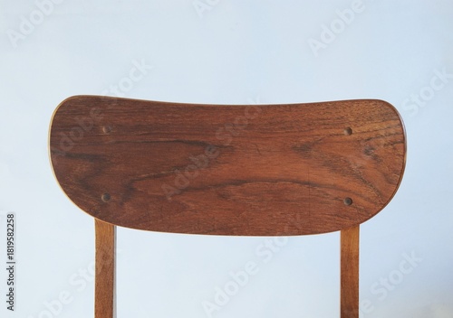 Close up on vintage dining chair in teak wood. Mid century modern design. 