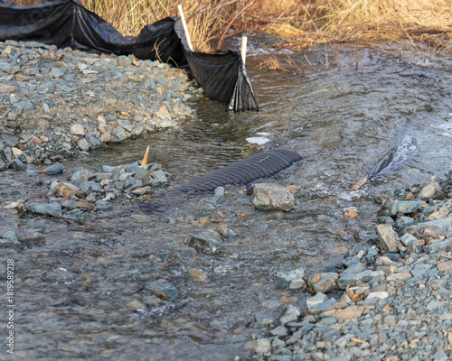 Flood damage on a small river caused by heavy rain and a small culvert.