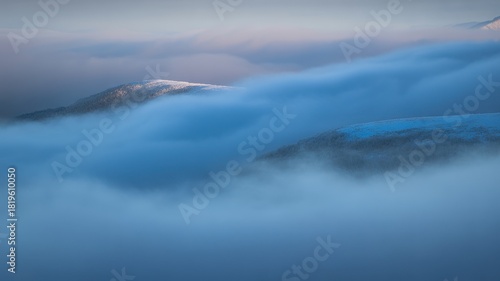 Fog over winter mountain peaks
