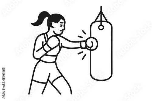 Powerful woman boxer training with a heavy punching bag in a gym setting