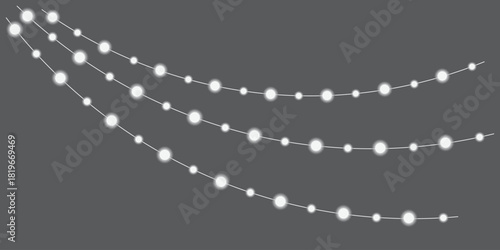 String lights hanging down on a dark gray background