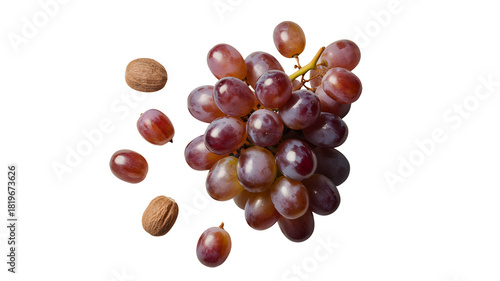 A ripe bunch of red grapes with scattered individual grapes and seeds isolated on transparent background