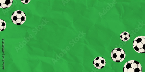 Soccer balls on green crumpled paper background.