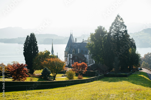 European castle in Switzerland with trimmed bushes and fall landscape