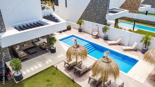 a view overlooking the luxury garden and swimming pool of mediterranean mansion