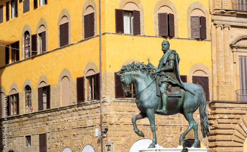 Equestrian Statue in Front of Historic Italian Town Hall Building with Ornate Facade and Tower