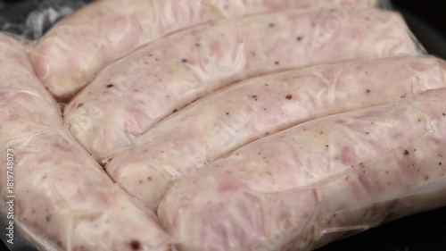 Fresh sausages ready for frying in a kitchen setting