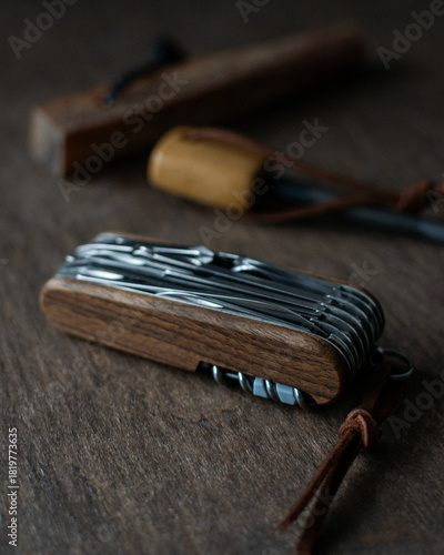 Multi-tool pocket knife and fire starter in the background