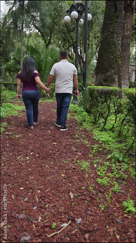 Romantic Couple Walking Hand in Hand on a Red Gravel Path in Historic ...