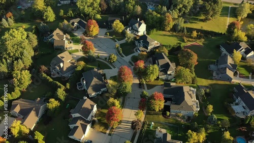 Establishing shot of Midwestern United States. American neighborhood in Fall season. Aerial view of houses. Small town