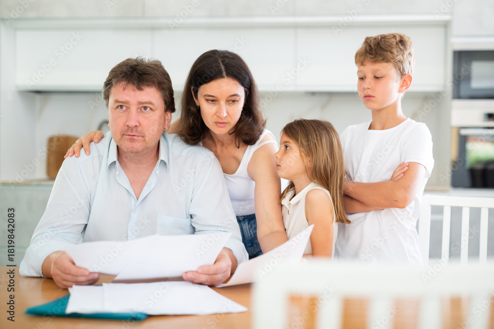 Fototapeta premium Upset family with documents having financial problems