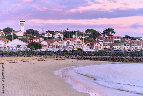 Saint-Jean-de-Luz Basque Country France Coastal Scenery with houses, beach and pier at dawn