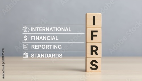 IFRS acronym spelled out on wooden blocks with corresponding words and icons, representing financial reporting standards.