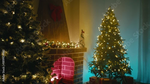 Christmas Trees Near the Fireplace in the Room Illuminated Cozy Atmosphere