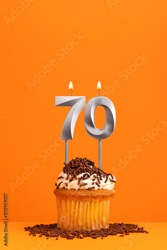 Birthday candle number 70 - Invitation card with orange background. Cupcake