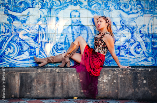 Woman posing in front of azulejos wall at Estoi Palace, Algarve, Portugal