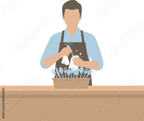 Man in apron polishes silverware with a cloth, standing behind a counter with a container of cutlery.