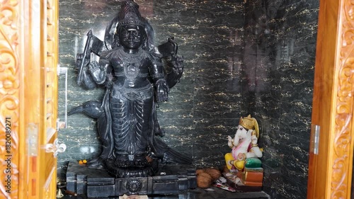hindu holy black stone shani dev idol placed inside traditional temple
