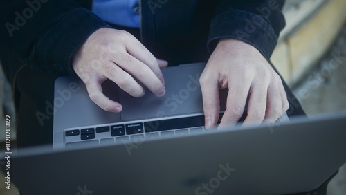 Hands Typing on Laptop Keyboard in Natural Light