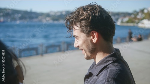 Man Smiling by the Water in Bright Sunshine