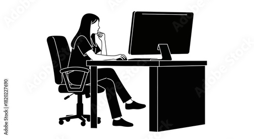 Professional woman thoughtfully working at her computer in the office