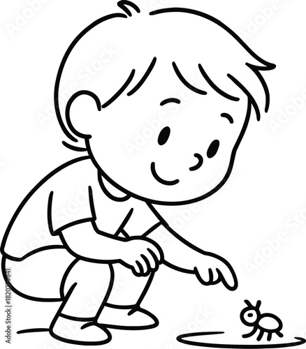 Little boy crouching down to observe a small insect closely outside