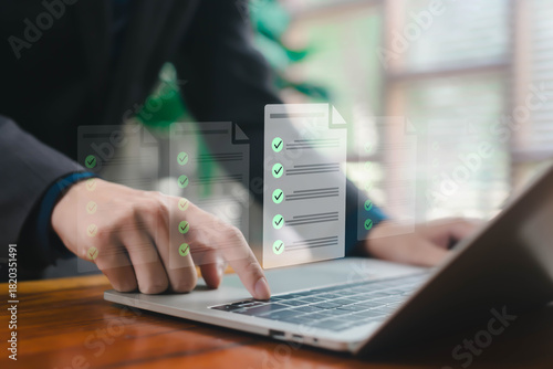Photos A business professional managing multiple digital checklist documents on a lapto