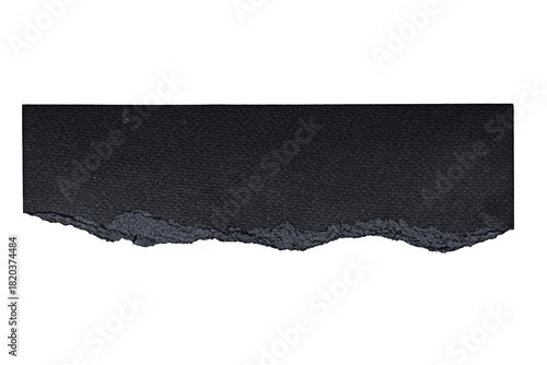 A close up view of a dark gray rectangular object with a jagged edge on a black background
