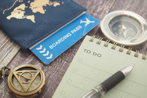 Planning travel with a passport, boarding pass, and compass