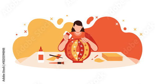 A woman carefully crafts a vibrant paper lantern, using glue and tools, on a table with a warm, abstract background.