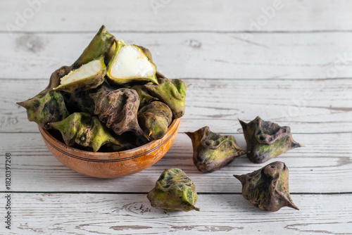 Water chestnut is a crunchy aquatic vegetable with sweet mild flavor, rich in fiber, antioxidants, vitamins, gluten-free, often used in snacks and curries.
