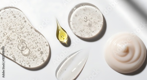 Assortment of skincare product textures including gel cream oil and scrub on white