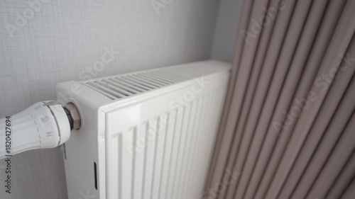 Wallpaper Mural Adjusting the radiator temperature in a living room Torontodigital.ca