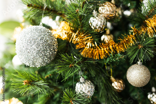 christmas tree with gold and silver decorations including stars and tinsel