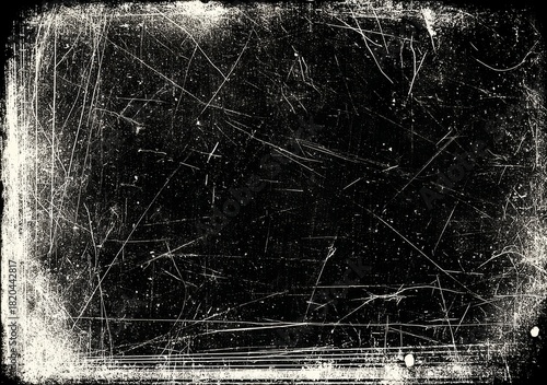 Grunge texture featuring white scratches and dust on a deep black background.