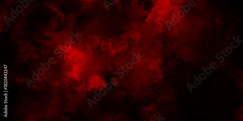A dark dramatic background with intense red and black smoke-like clouds, creating a fiery, atmospheric effect. red grange powder explosion cloud on black background. red scary horror movie background.