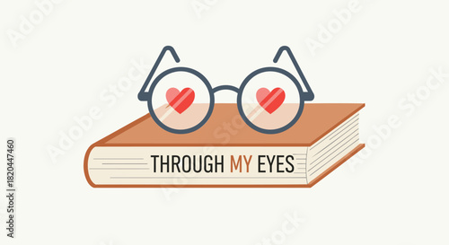 A pair of glasses with red hearts inside the lenses rests on an open book with the words through my eyes printed on its cover